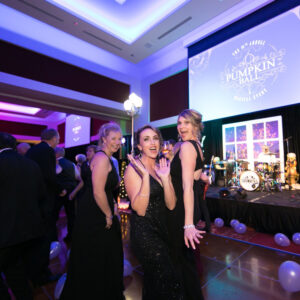 Women dancing to a live band in formal wear