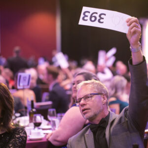 Man holding an auction paddle