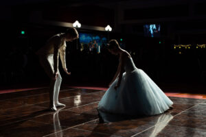 Two dancers from the ballet face and bow towards each other before their choreographed routine begins