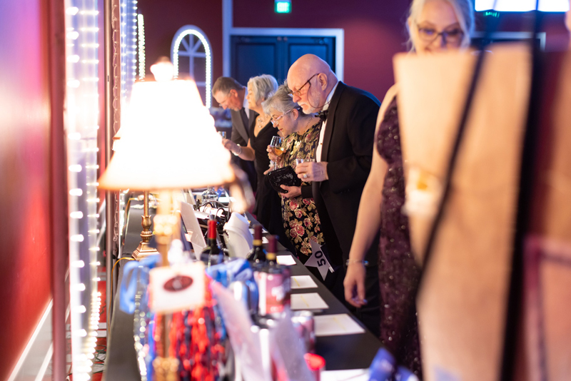 Attendees participate in the silent auction that benefits Vanessa Behan